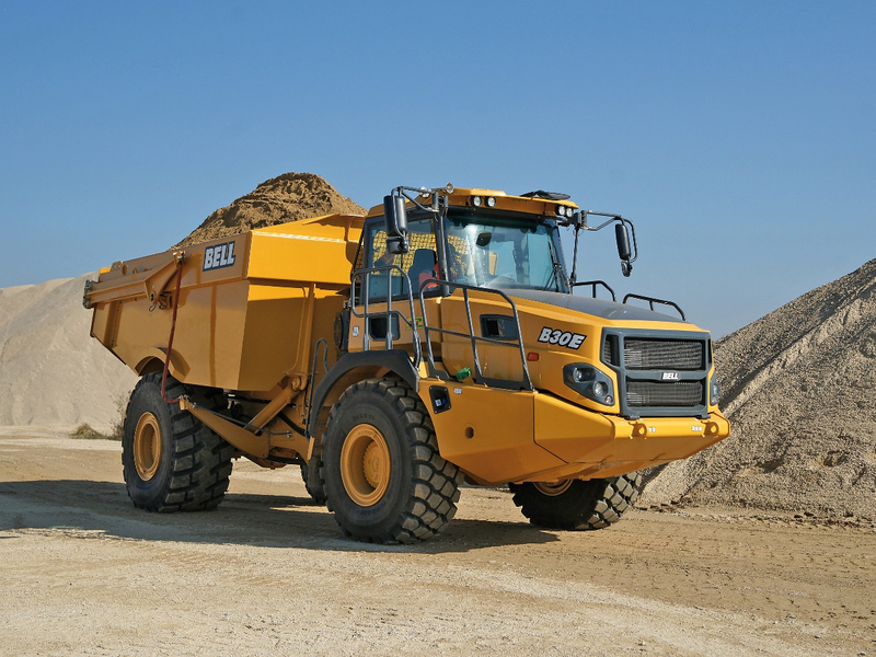 A truck driving down a dirt road

Description automatically generated